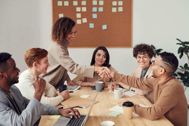 Team members shaking hands after a successful meeting
